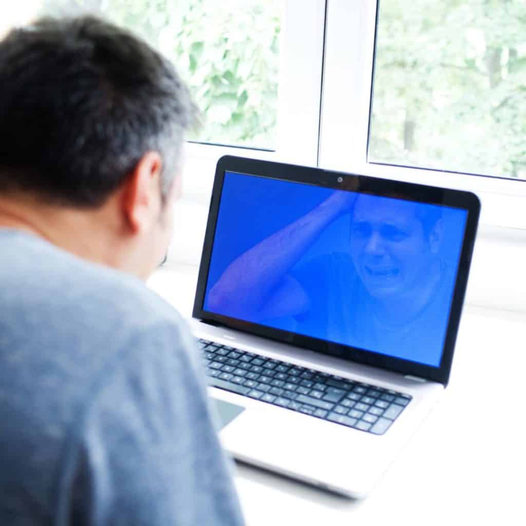 Man staring a blue screen on his laptop