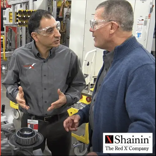 John Abrahamian on the production floor at a client having a conversation about a complex problem