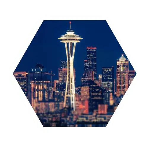 Seattle skyline at night in a hexagon frame
