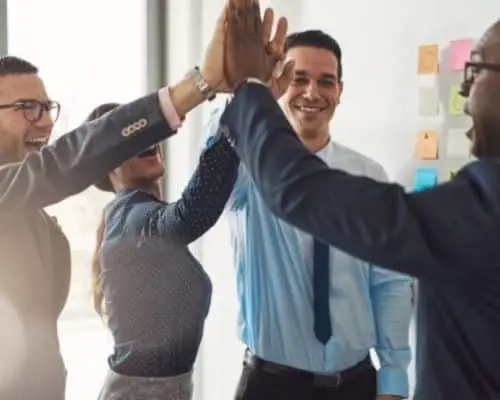 Problem Solving team high-fiving at the conclusion of their project