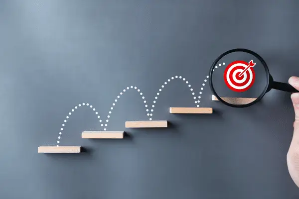 A target on the final step of a set of floating wood shelves. The target is shown with a magnifying glass around it to emphasize results.